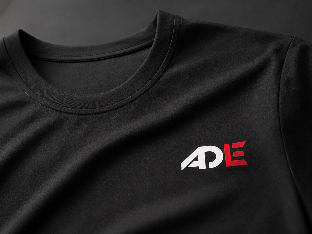 Close-up of black Cloud Ascend Tee fabric, collar, and chest logo