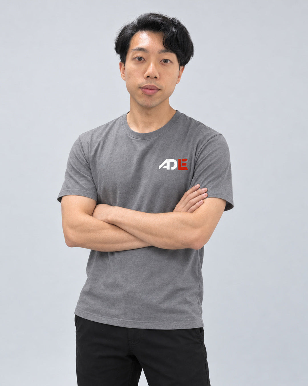 Cloud Ascend™ Tee in Gray — relaxed arms-crossed on-body fit